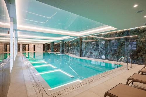 a large swimming pool in a building at Tavel Hotel & SPA in Bukovel