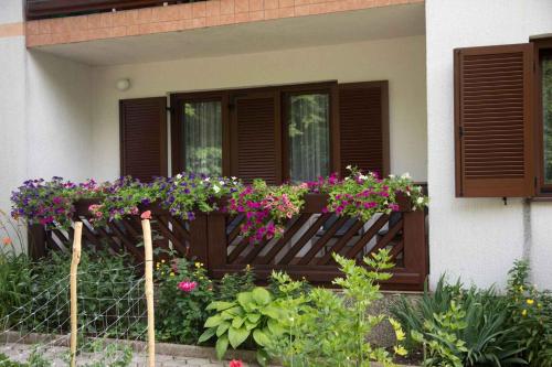 a house with flowers on a wooden fence at Holiday home in Lokve, Croatia 47707 in Lokve