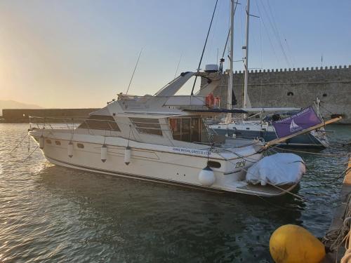 a white boat is docked in the water at ZEN in Heraklion