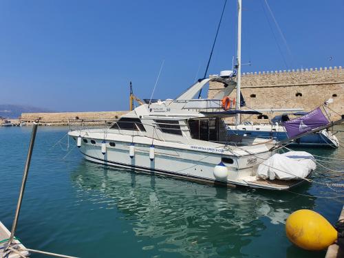 a white boat is docked in the water at ZEN in Heraklion