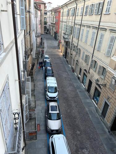 a row of cars parked in an alley at Casa Piemont in Casale Monferrato