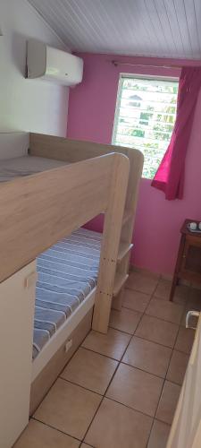 a bunk bed in a room with a window at flech kann in Fort-de-France