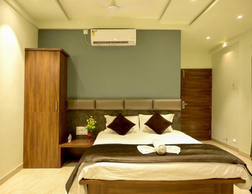 a bedroom with a large bed with a bow on it at Hotel Limelight in Kudal