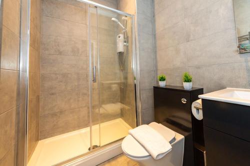 a bathroom with a shower and a toilet and a sink at One Bedroom Apartments in Liverpool City Centre in Liverpool