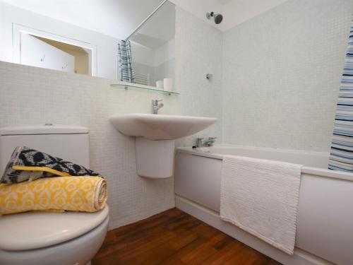 a bathroom with a toilet and a sink and a tub at 1 bed in Westward Ho 61767 in Westward Ho