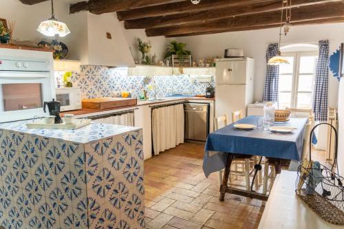 a kitchen with blue and white tiles on the counters at Mas Gran de Cruïlles - Mas Rural - Hotel & Events in Cruïlles