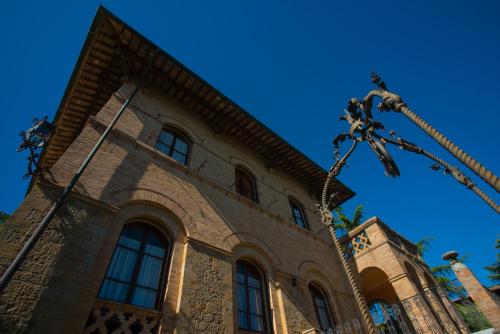 an old building with a cross in front of it at Appartamenti Villa Mascagni in Volterra
