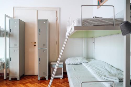 a bedroom with two bunk beds and a ladder at Hostel Beogradjanka in Belgrade