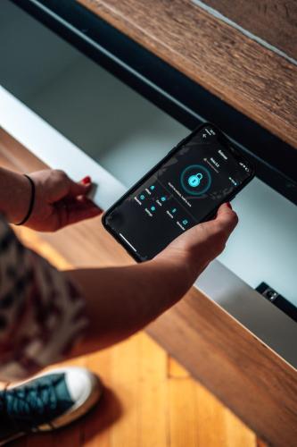 a person holding a remote control in a drawer at Hostel Beogradjanka in Belgrade