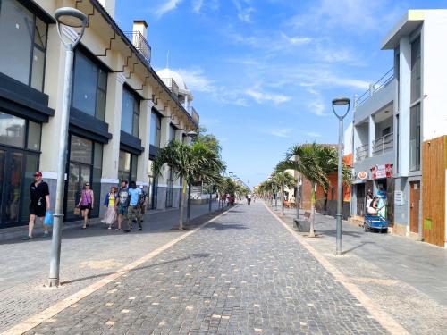 a cobblestone street in a city with people walking at Studio Apt Bounty Condominium, Santa Maria in Santa Maria