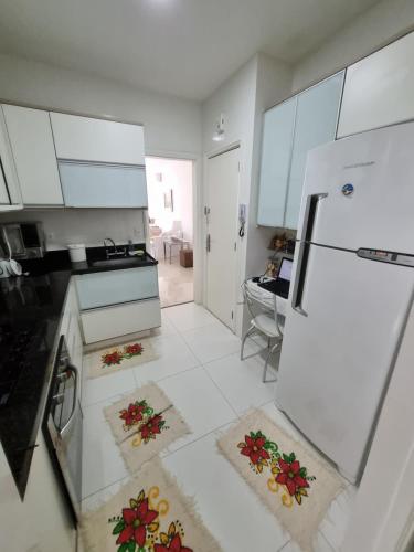 a kitchen with white cabinets and a white refrigerator at Quarto confortavel privativo Copacabana in Rio de Janeiro