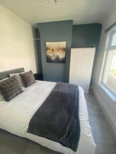 a bedroom with a large bed in a room at Ideal for Contractors' Accommodation in Seacombe