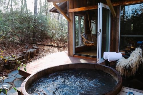 a hot tub in the backyard of a house at The Forest Bathhouse - Sauna, Soak, & Luxury in Fairview