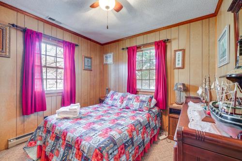 a bedroom with pink curtains and a bed in it at Kill Devil Hills Vacation Rental, Walk to Beach! in Kill Devil Hills