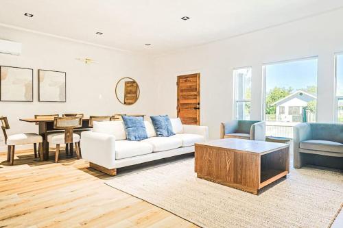 a living room with a white couch and a table at LA Retreat: Stylish 3BR Villa in Los Angeles