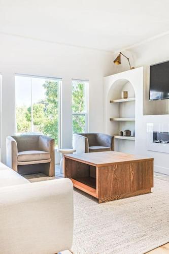 a living room with a coffee table and two chairs at LA Retreat: Stylish 3BR Villa in Los Angeles