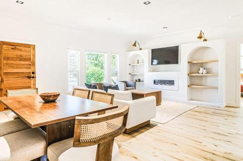 a living room with a wooden table and chairs at LA Retreat: Stylish 3BR Villa in Los Angeles