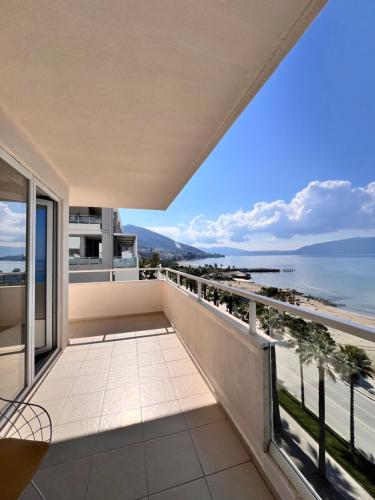 a balcony with a view of the ocean at Maxi Room in Vlorë