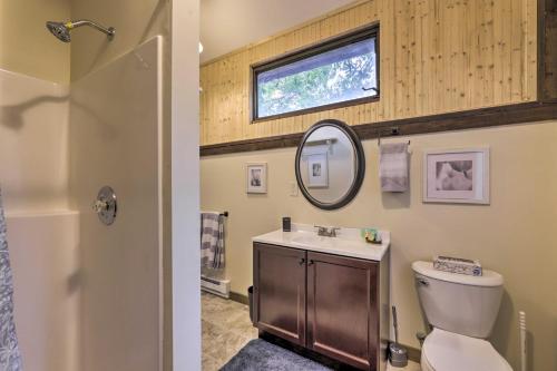 a bathroom with a toilet and a sink and a mirror at Private Guest House with Deck and Spectacular Views! in Uncasville