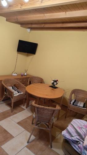 a dining room with a wooden table and chairs at t45yhfg in Pobierowo