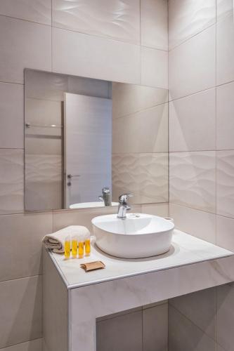 a bathroom with a sink and a mirror at Beach Break Rhodes in Faliraki