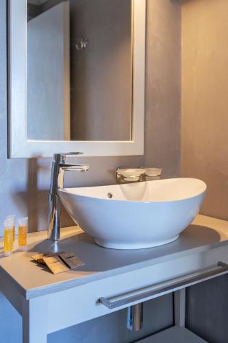 a white sink on a counter in a bathroom at Beach Break Rhodes in Faliraki