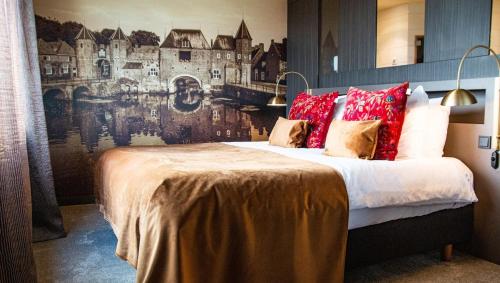 a bedroom with a large bed with red pillows at Van der Valk Hotel Amersfoort-A1 in Amersfoort