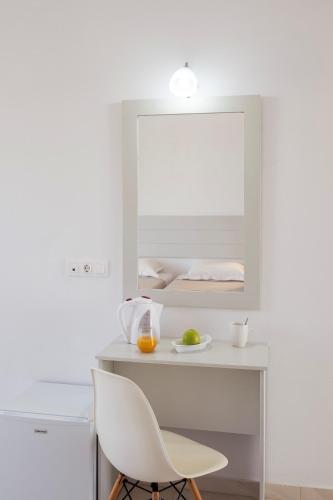 a white desk with a white chair and a mirror at Beach Break Rhodes in Faliraki