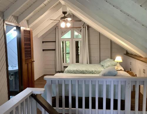 a bedroom with a bed and a window at Patti's Paradise in Sandy Bay