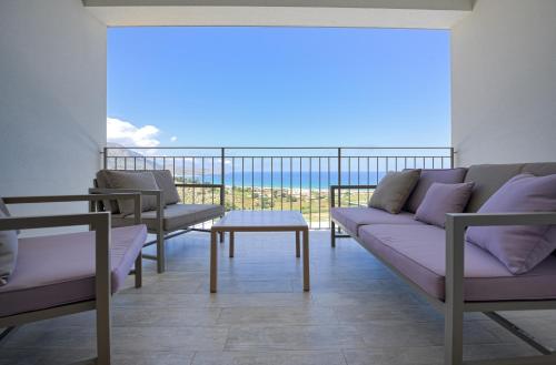 a living room with a couch and a table at La Blanca Resort & Spa in Castellammare del Golfo
