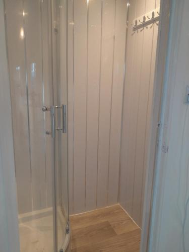 a shower with a glass door in a bathroom at Immaculate 2-Bed Apartment in Mablethorpe in Mablethorpe
