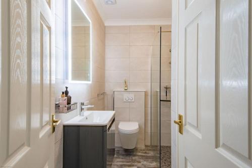 a bathroom with a white toilet and a sink at Sea View Apartment in Folkestone