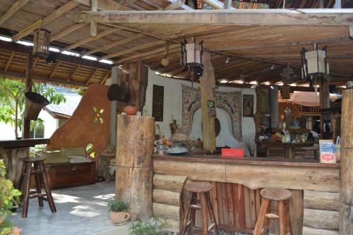 a bar in a restaurant with stools and a counter at Thai Terrace Bungalow in Thong Nai Pan Yai