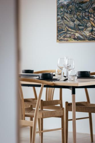 a wooden table with wine glasses on top of it at Kerbyggd: Luxury house and cottage in golden circle in Selfoss