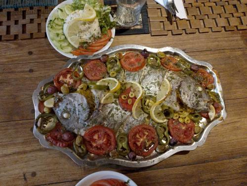 a tray of food with tomatoes and vegetables on a table at Riad & Restaurant Ocean Beach Douira in Agadir