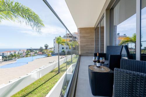 a balcony with a table with wine glasses on it at The Queen Apartment By Sam Houses in Funchal