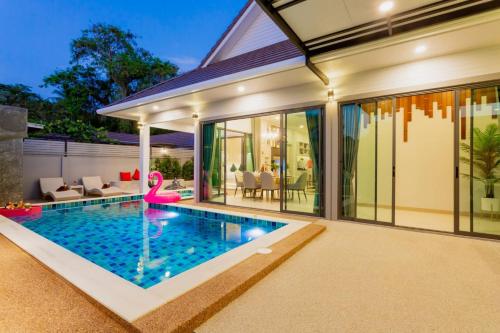 a swimming pool in the backyard of a house at Nut & Non Pool Villa by Duangtham in Ban Khlong Haeng