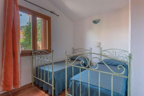 En eller flere senge i et værelse på Apartments in Budoni 39547