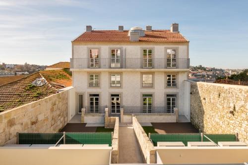 a large white house with a balcony on a wall at Host Wise - Fervença Boutique Palace in Vila Nova de Gaia
