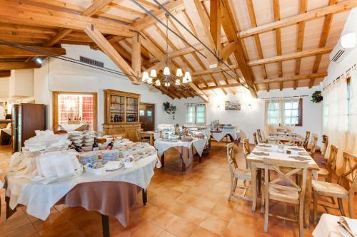 a dining room with tables and chairs in a building at Apartments in Magliano in Toscana - Maremma-Küste 48277 in Magliano in Toscana
