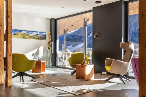 a living room with chairs and a table at Stoana Apt 3-4 in San Giacomo