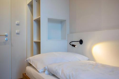 a bedroom with a bed with a lamp on it at Stoana Apt 3-4 in San Giacomo