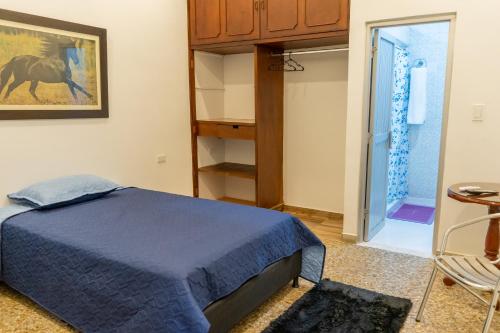 a bedroom with a bed and a walk in closet at HOTEL GANADERO in La Dorada