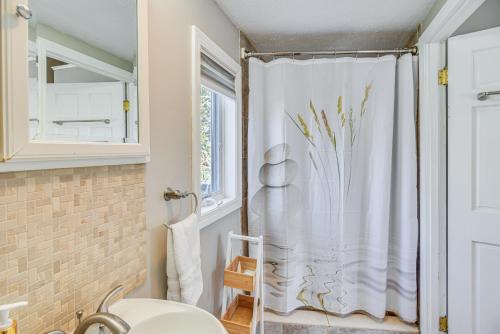 a bathroom with a shower curtain and a toilet at Downtown Westerly Home 4 Mi to Beaches! in Westerly