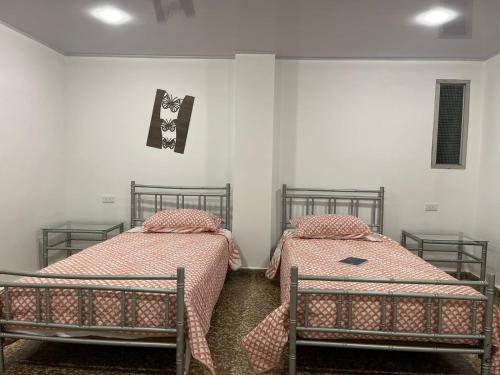 two beds sitting next to each other in a room at HOTEL GANADERO in La Dorada