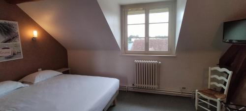 a bedroom with a white bed and a window at Hôtel Restaurant Le Moulin de la Renne Adults Only proche Zoo de Beauval in Thésée