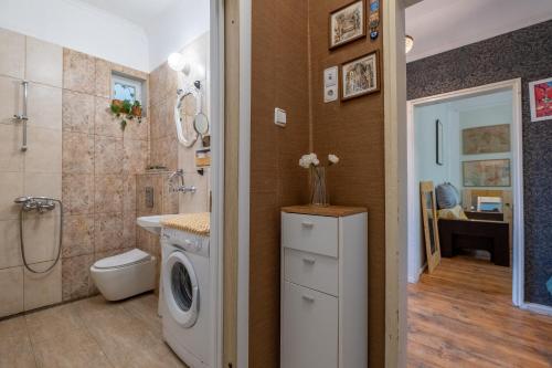 a bathroom with a washing machine next to a shower at Classy apartment in Sofia