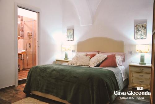 a bedroom with a bed with two night stands and two lamps at Bed and Breakfast Casa Gioconda in Gaeta