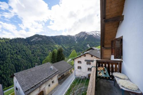 a balcony with a view of a mountain at Chasa Rosa in Vna
