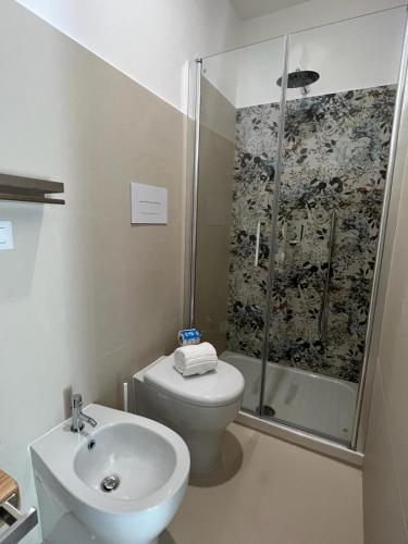 a bathroom with a shower and a toilet and a sink at B&b Villa Jasmine in Palinuro